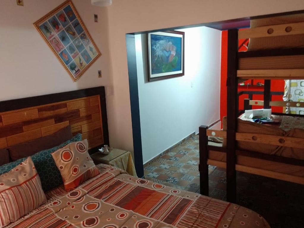 a bedroom with a bed and a dresser in it at Casa Mexicana Patio in Mexico City