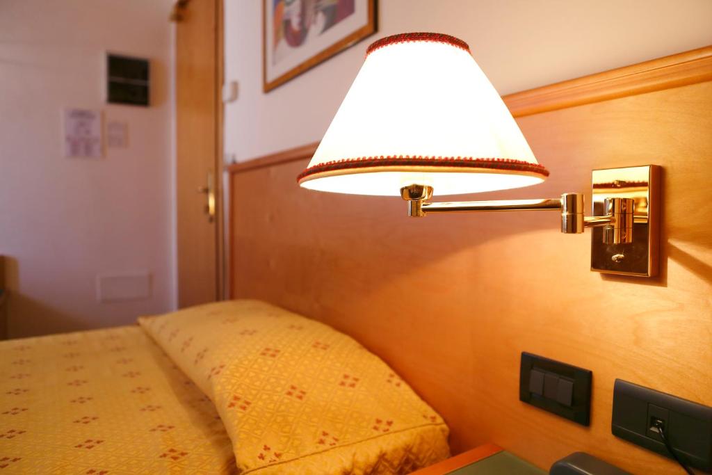 Postel nebo postele na pokoji v ubytování Hotel Estense