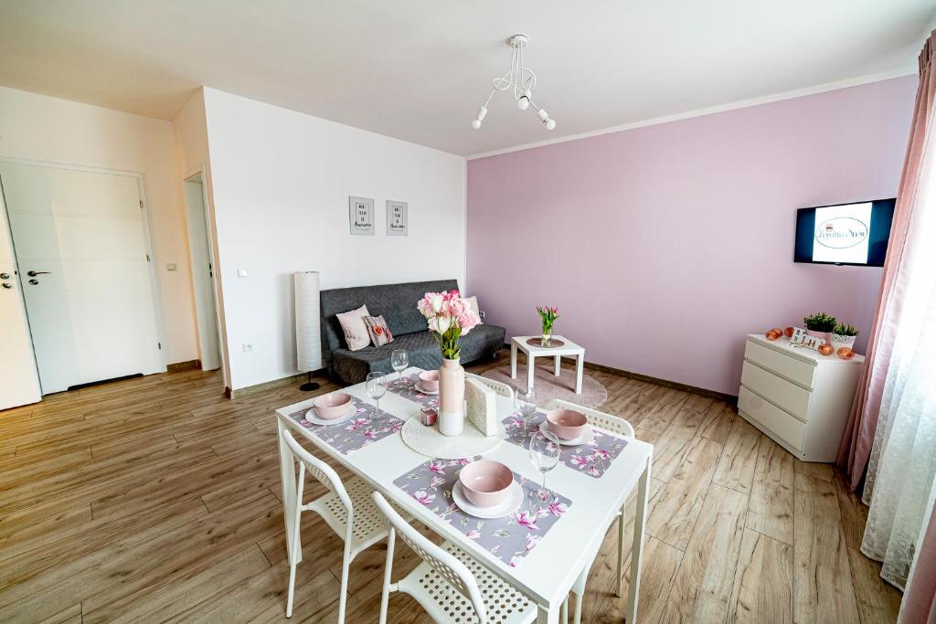 a living room with a white table with flowers on it at Kopalnia Snów in Wieliczka