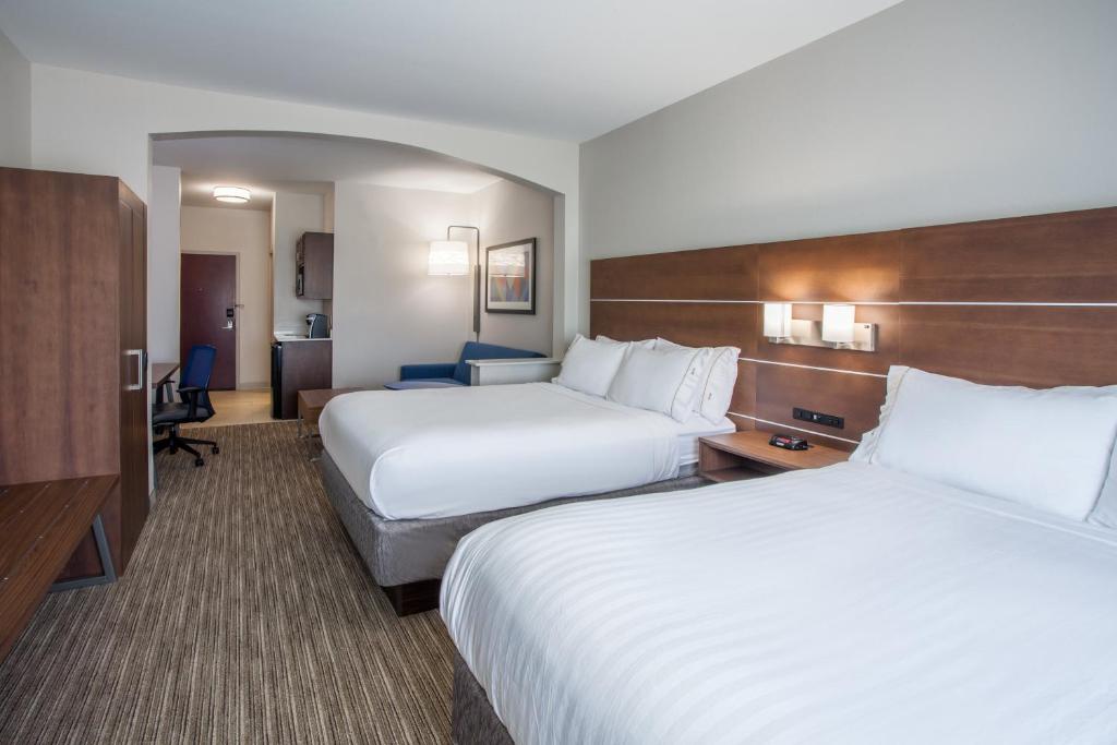 a hotel room with two beds and a television at Holiday Inn Express & Suites Texarkana by IHG in Texarkana