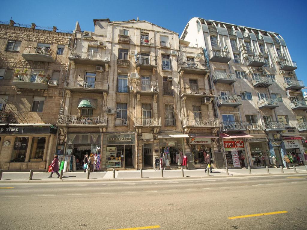 a large building on a street in front of a building at Paamonim Studios in Jerusalem