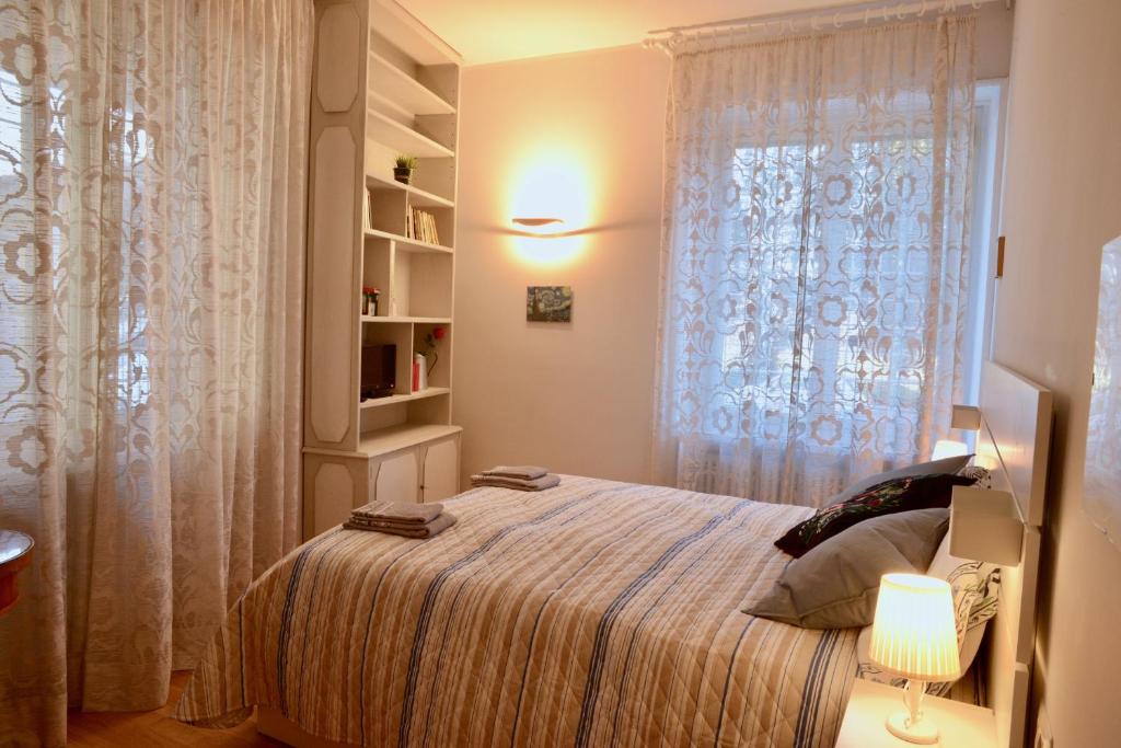 a bedroom with a large bed and a window at BREZZA MARINA in Rome