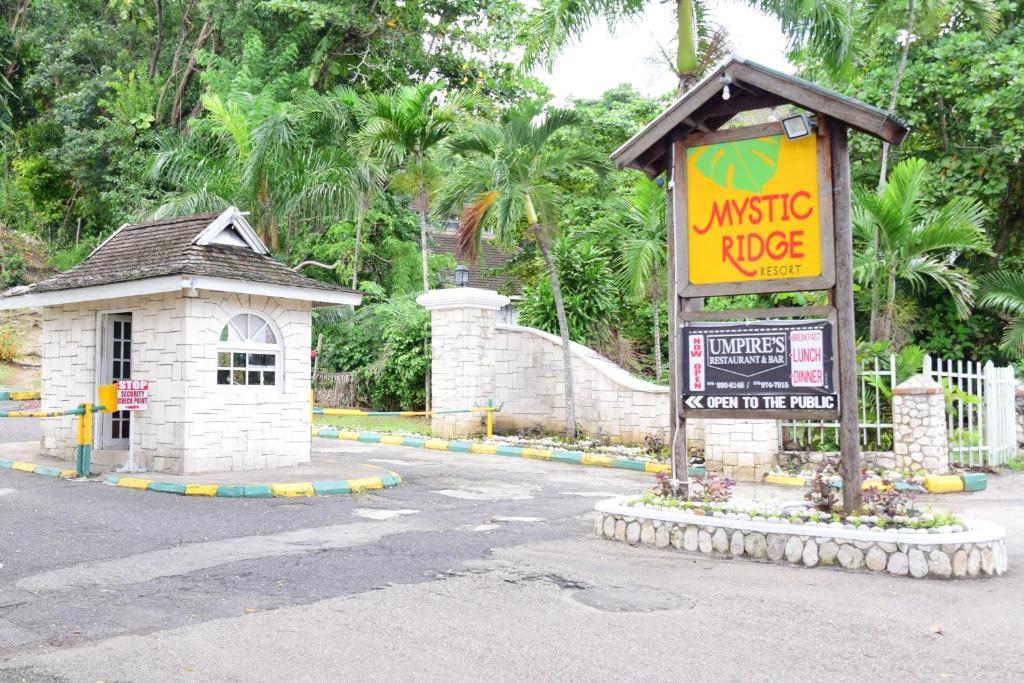 a sign in the middle of a street next to a building at Poolside Mystic Apt 9A in Ocho Rios
