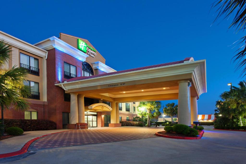 a hotel with a building with a parking garage at Holiday Inn Express & Suites Wharton, an IHG Hotel in Wharton