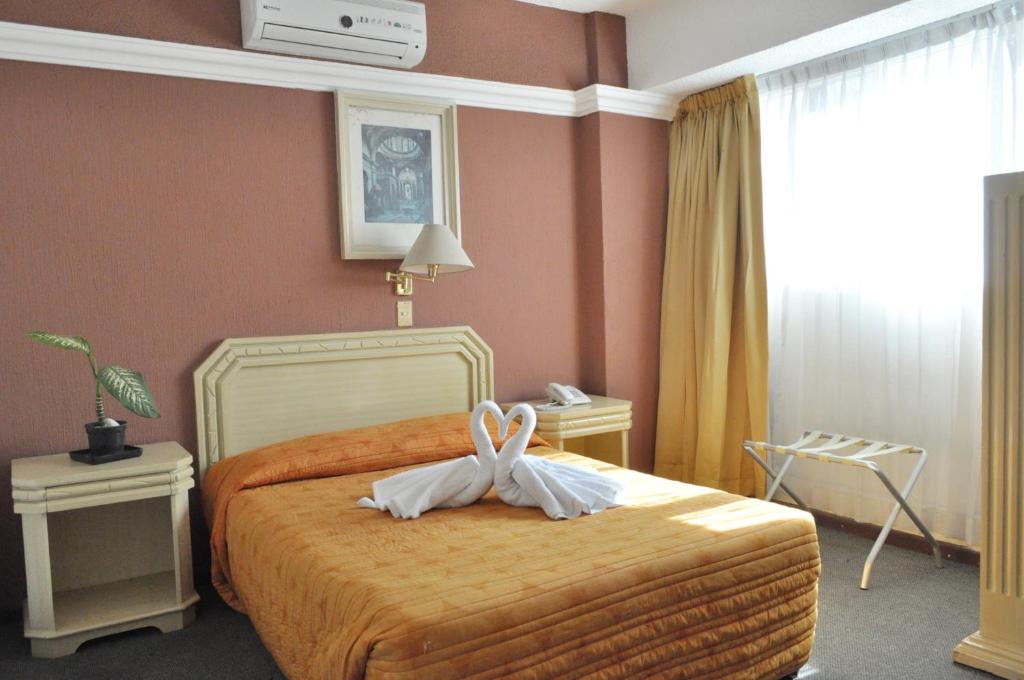 Ένα ή περισσότερα κρεβάτια σε δωμάτιο στο Hotel María Teresa