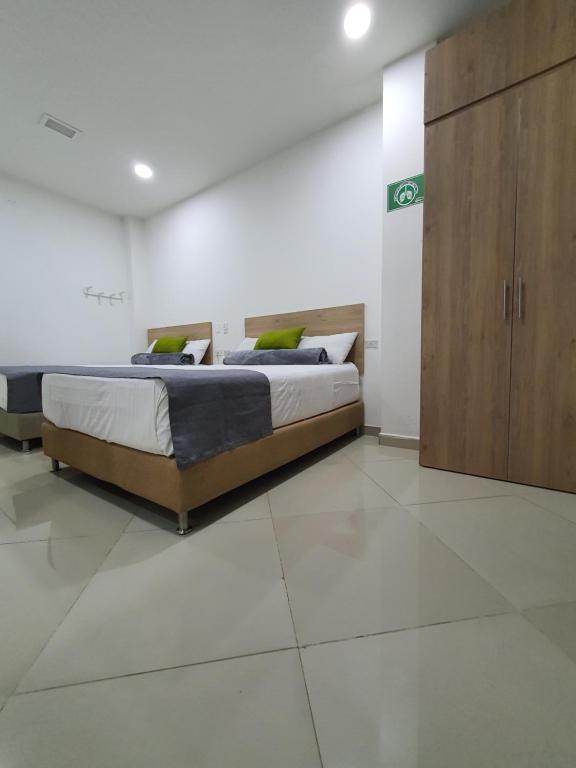 Postel nebo postele na pokoji v ubytování Hotel Laureles Park