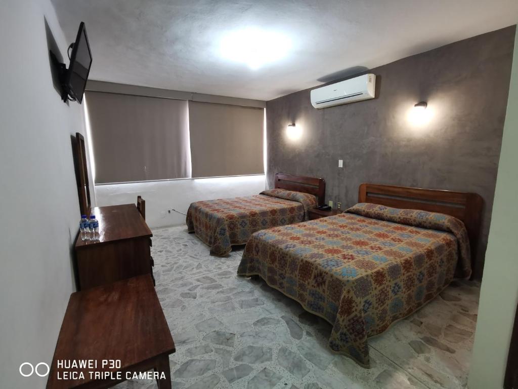Postel nebo postele na pokoji v ubytování Hotel Plaza