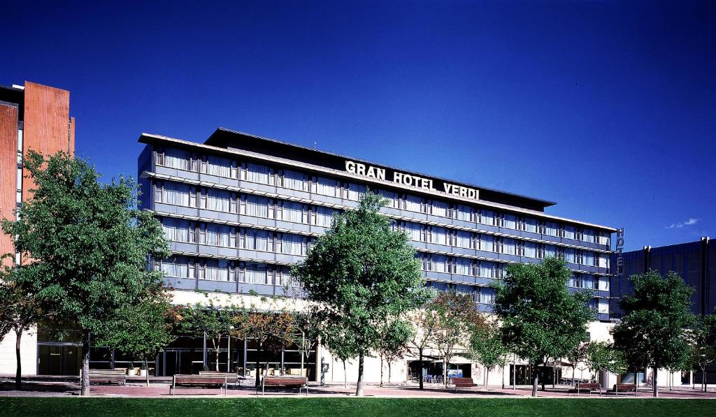 a large building with a sign on the top of it at Catalonia Gran Hotel Verdi in Sabadell