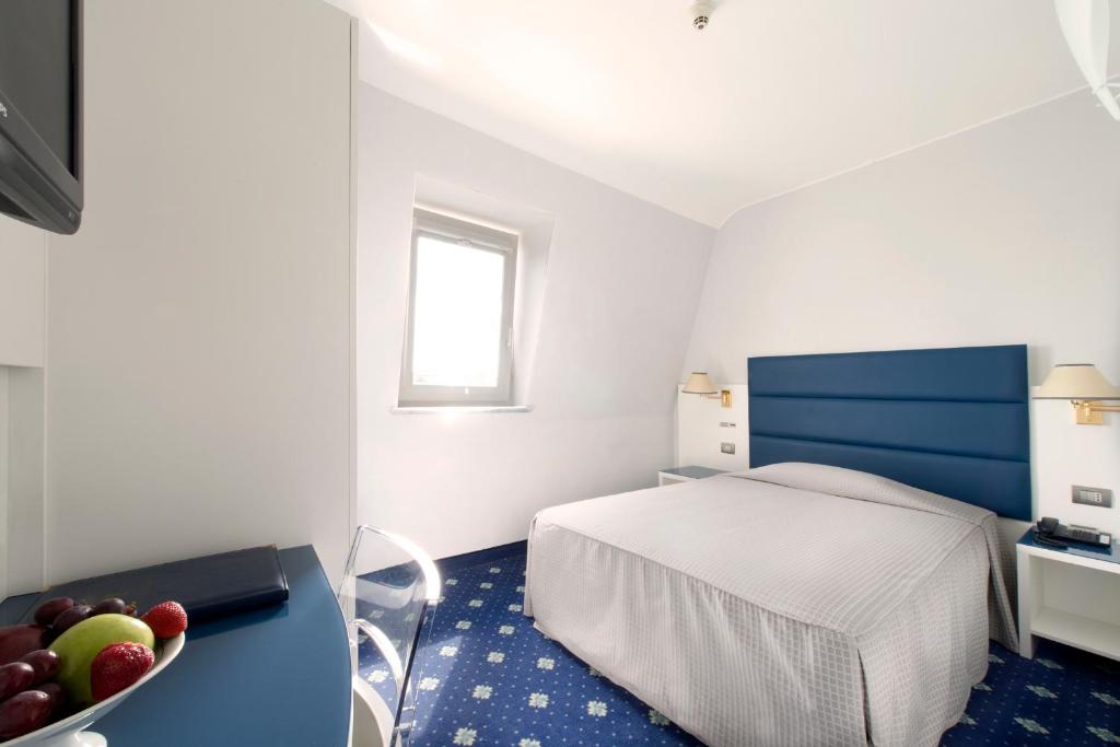 Postel nebo postele na pokoji v ubytování Hotel Estense