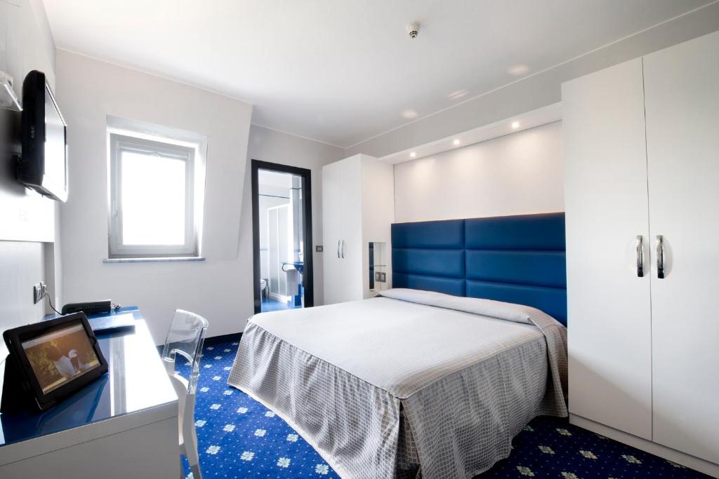 Postel nebo postele na pokoji v ubytování Hotel Estense