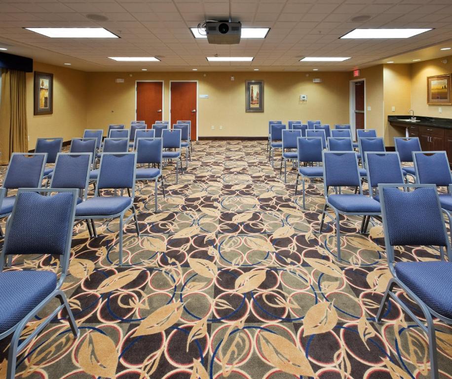 a conference room with blue chairs and a carpet at Holiday Inn Express and Suites Great Falls by IHG in Great Falls
