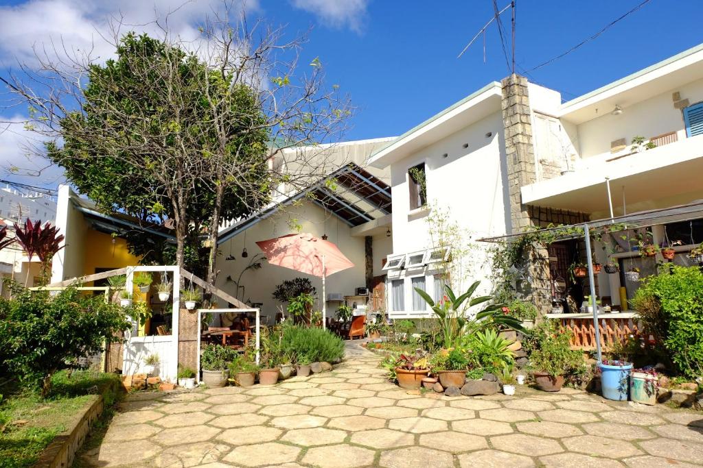 a house with a courtyard in front of it at The Kadupul Homecation in Da Lat