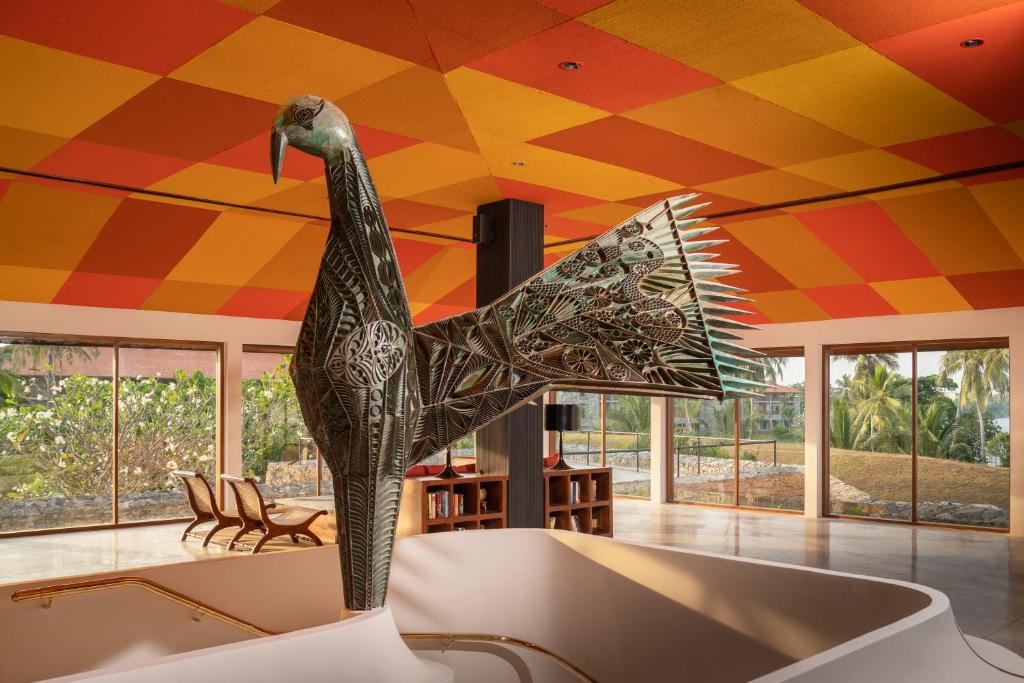 a statue of a bird in a room with a colorful ceiling at Cinnamon Bentota Beach - Signature Selection in Bentota