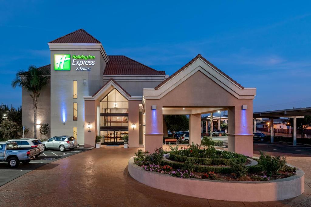 a hotel front of a building with a parking lot at Holiday Inn Express Lathrop - South Stockton, an IHG Hotel in Lathrop