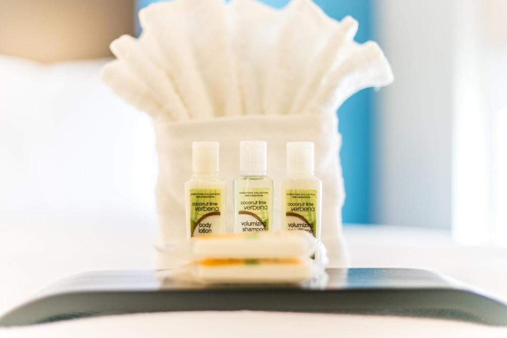 a group of three bottles of lotion and a toothbrush at Holiday Inn & Suites Chattanooga Downtown by IHG in Chattanooga