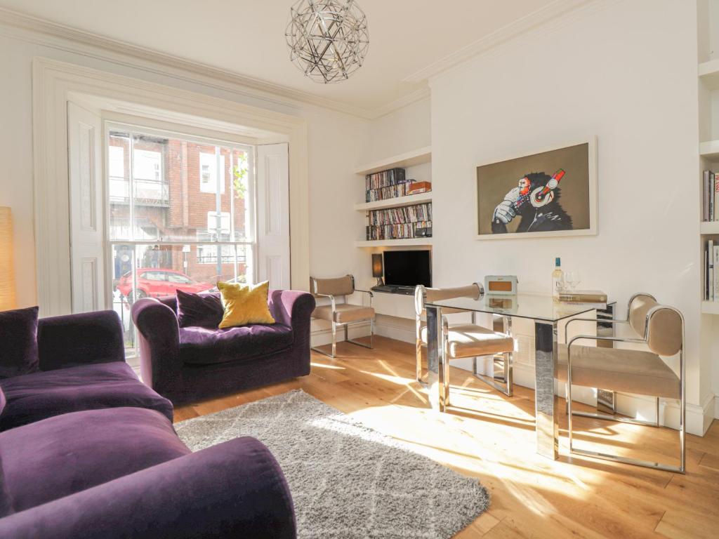 a living room with a purple couch and a table at Mount Sion in Royal Tunbridge Wells