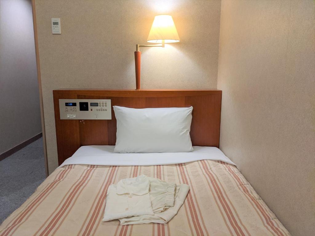 Postel nebo postele na pokoji v ubytování Toyama Jiyukan