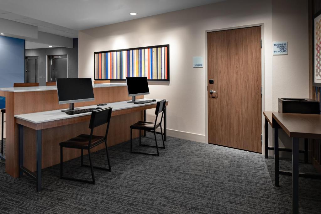 a lobby with a desk with two computers on it at Holiday Inn Express & Suites - Elkhorn - Lake Geneva Area by IHG in Elkhorn