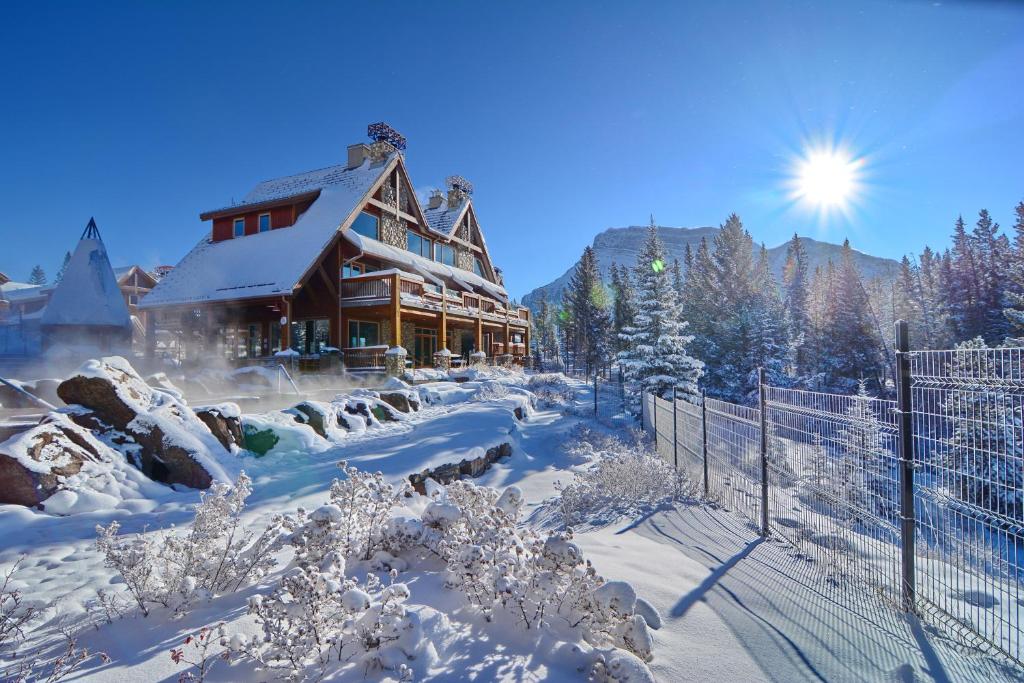 a snow covered ski lodge in the middle of a snowy landscape at The Hidden Ridge Resort in Banff