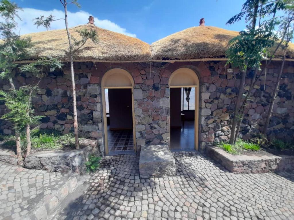 a stone house with a thatched roof at Ben Abeba Lodge & Tukul in Lalibela