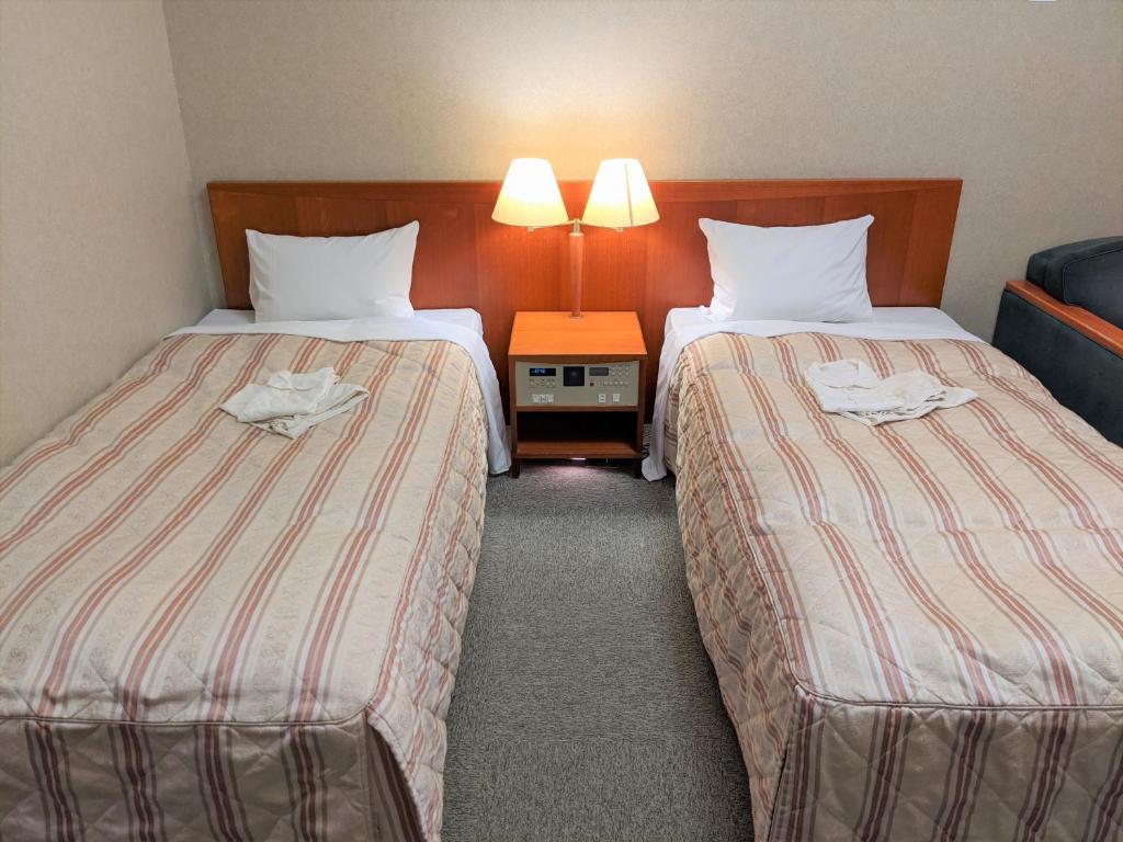 Postel nebo postele na pokoji v ubytování Toyama Jiyukan