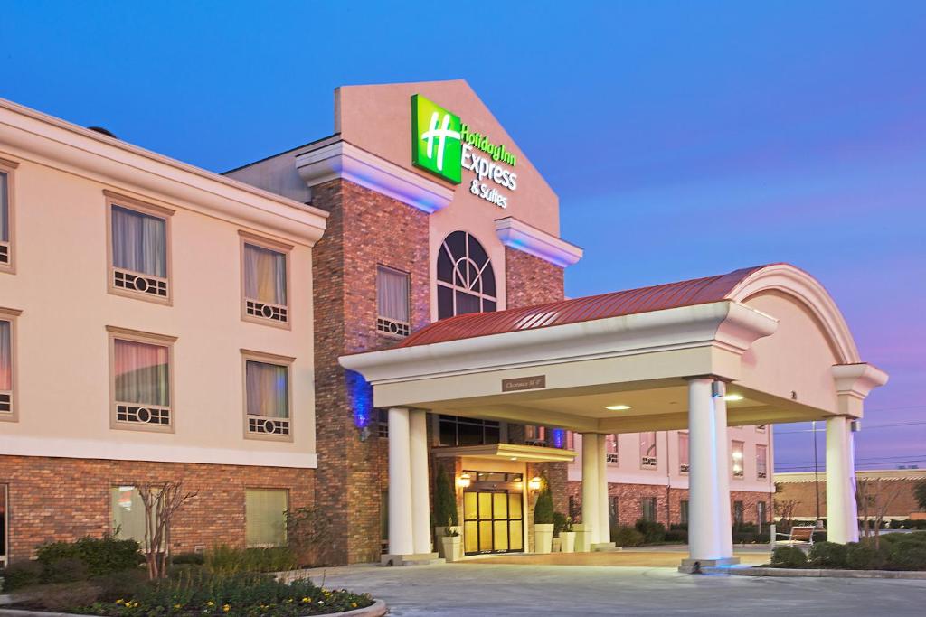 un hotel con un cartel en la parte delantera en Holiday Inn Express Hotel and Suites Conroe, an IHG Hotel, en Conroe