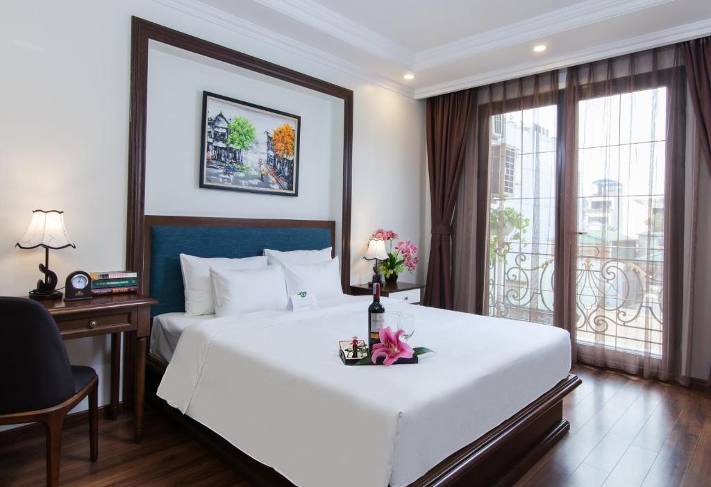 A bed or beds in a room at Hanoi Central Hotel & Residences