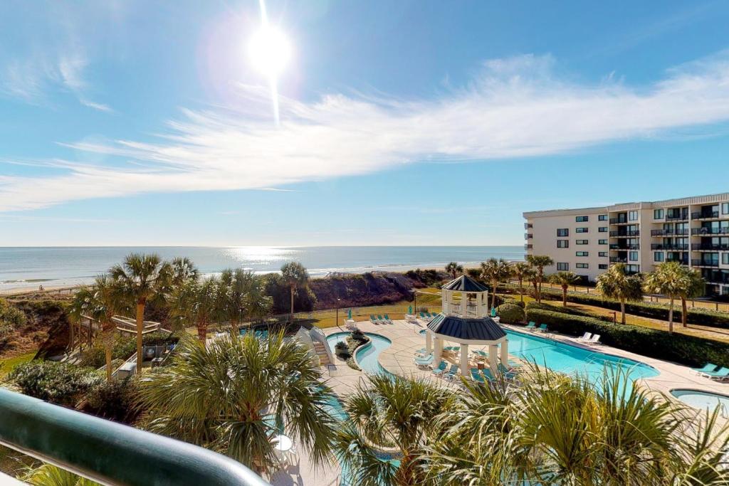 a view of a resort with a swimming pool and the ocean at Seaside Retreat in Litchfield Beach