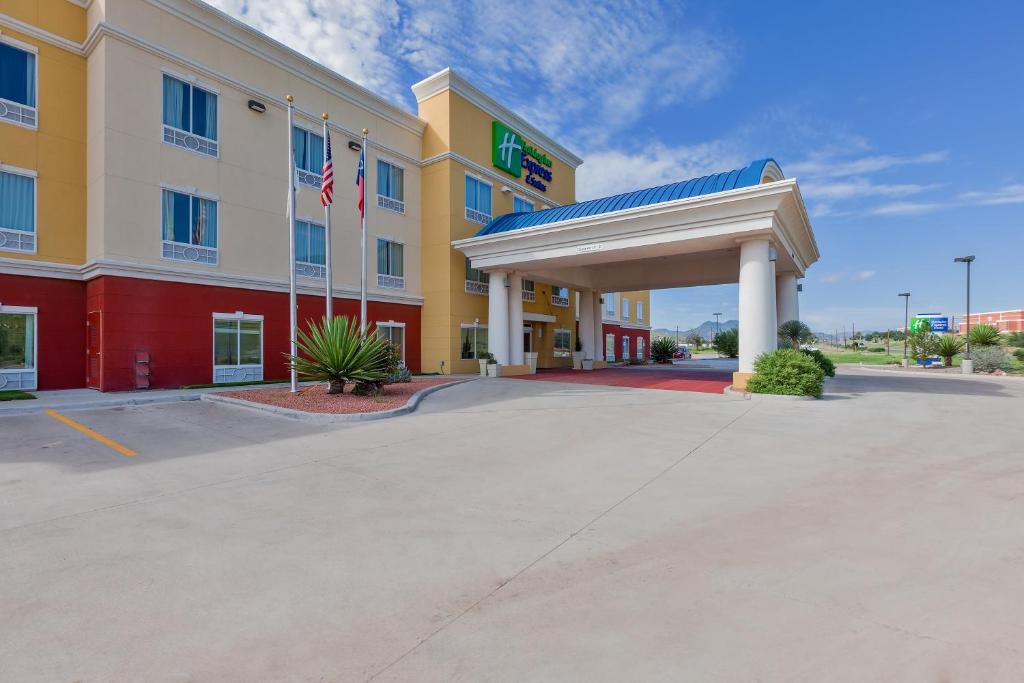 a hotel with a gas station in a parking lot at Holiday Inn Express and Suites Alpine, an IHG Hotel in Alpine