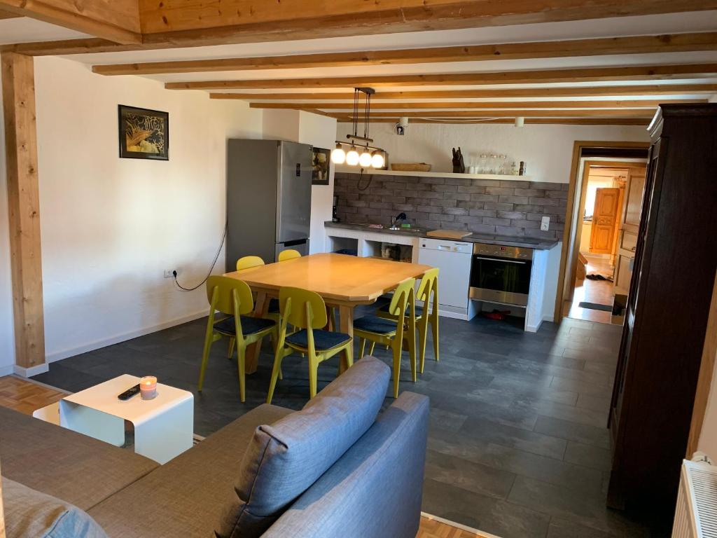 a kitchen and dining room with a table and chairs at Allgäuer Taucherhof in Aitrang