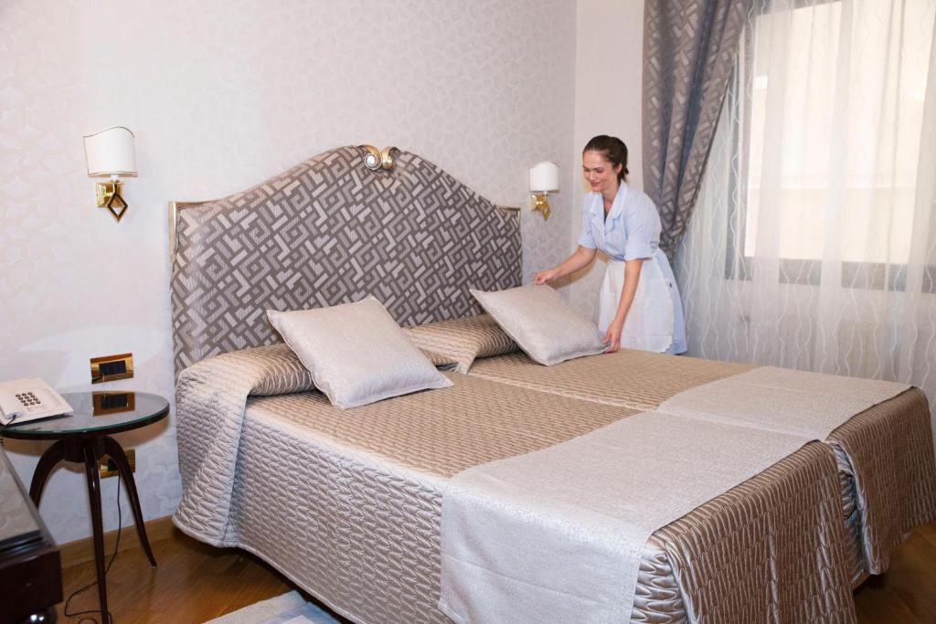 Postel nebo postele na pokoji v ubytování Hotel Europa