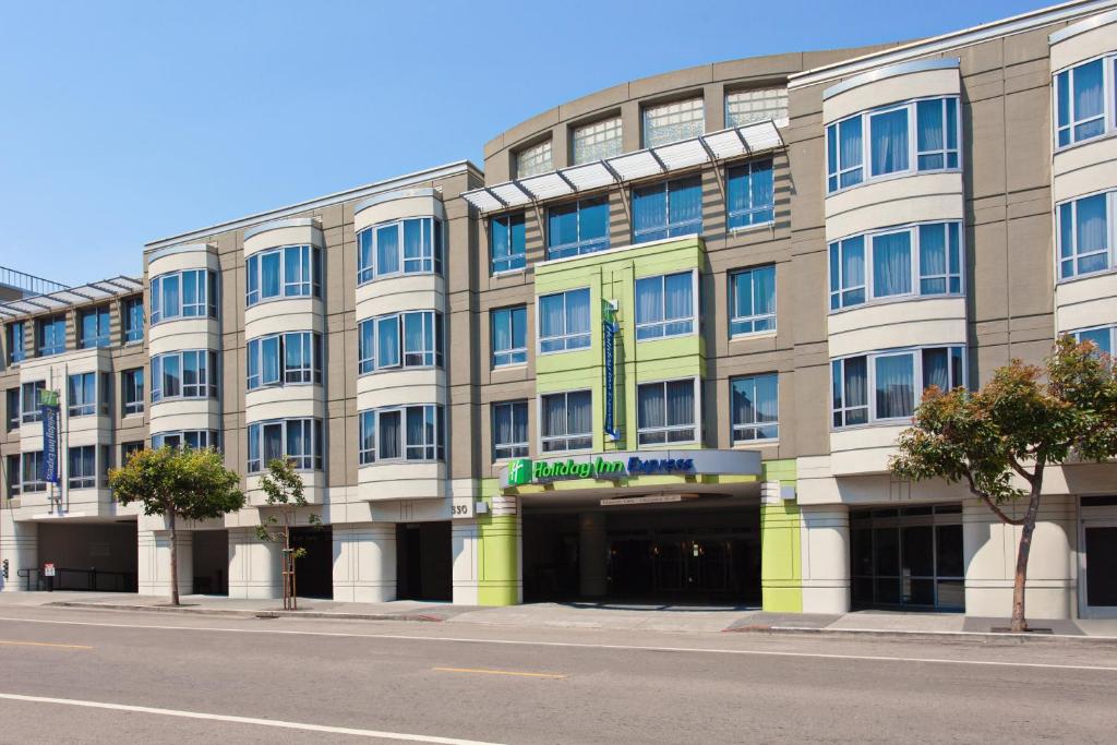a large building on a city street with a street at Holiday Inn Express Hotel & Suites Fisherman's Wharf, an IHG Hotel in San Francisco