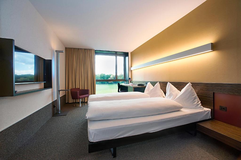 Postel nebo postele na pokoji v ubytování Hotel Ambassador