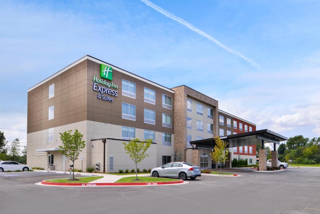 a hotel building with a car parked in a parking lot at Holiday Inn Express & Suites - Siloam Springs by IHG in Siloam Springs