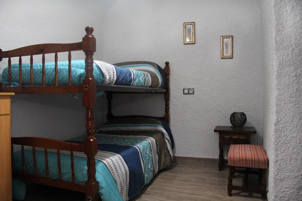 Postel nebo postele na pokoji v ubytování Cuevas Cañada de las Piedras