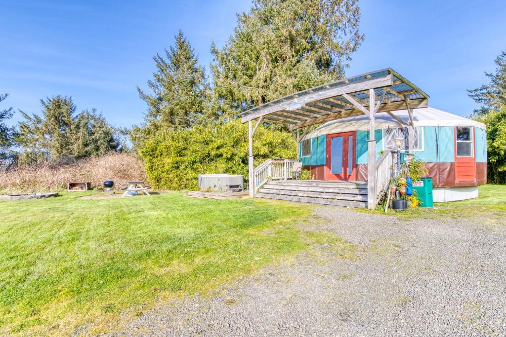 a tiny house in a field with a shed at Yurt on the Bay in Bay City