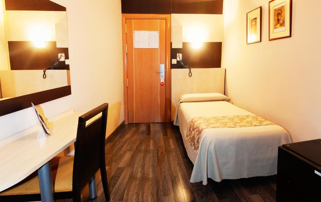 Postel nebo postele na pokoji v ubytování Hotel Universal