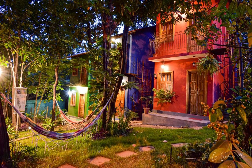 a hammock in front of a house at night at Chalés Natora in Lençóis