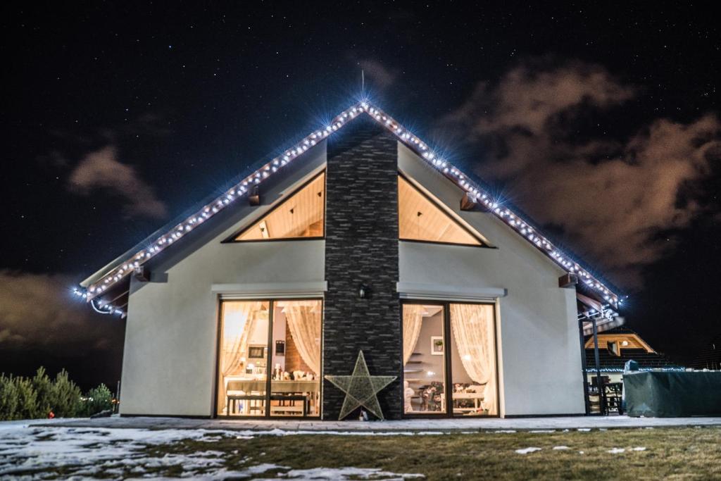 a house with lights on it at night at Chalet Dream High Tatras in Stará Lesná