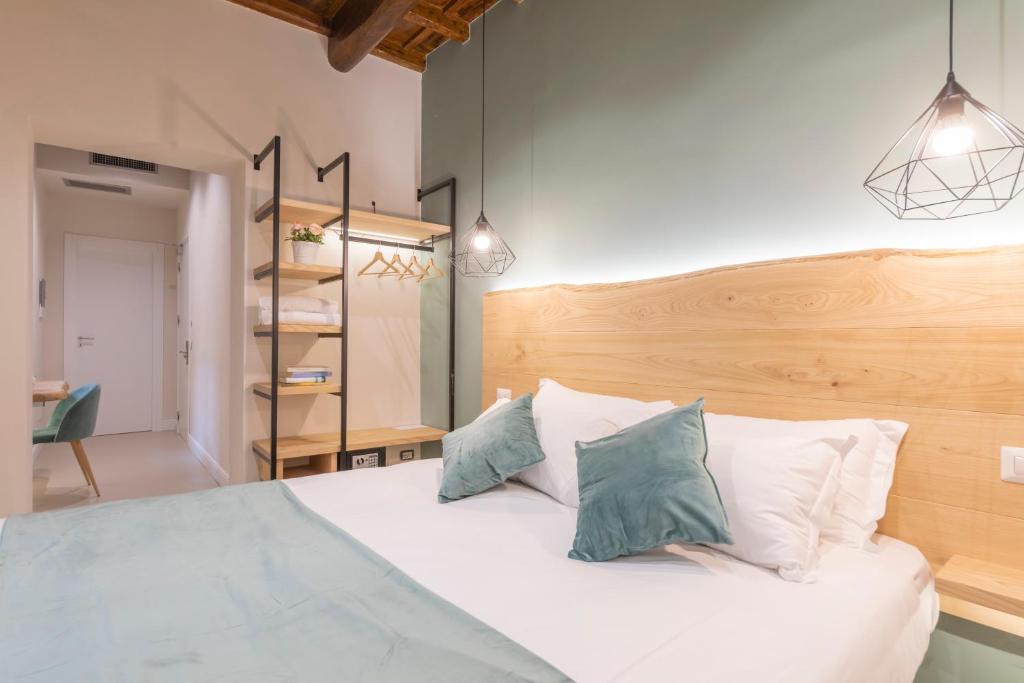 a bedroom with a white bed with two pillows at Campo de' Fiori 34 in Rome