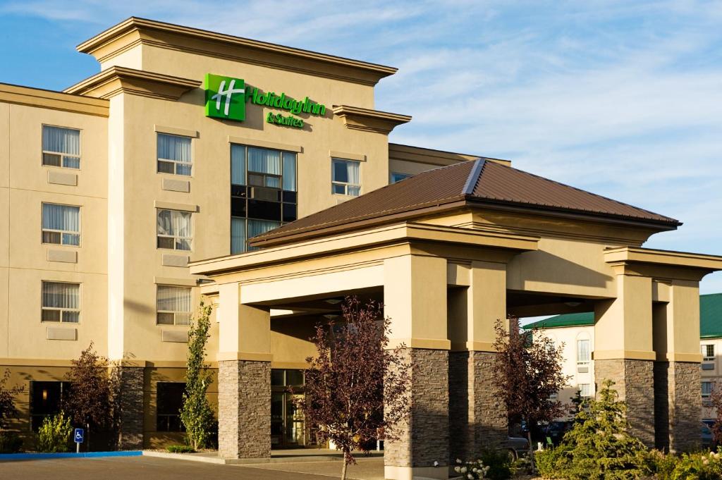 a hotel building with a sign on top of it at Holiday Inn & Suites Lloydminster, an IHG Hotel in Lloydminster