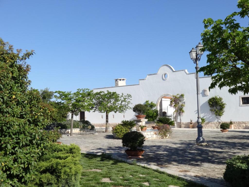 a white building with trees and a street light at Monteferraro Vacanze in Turi