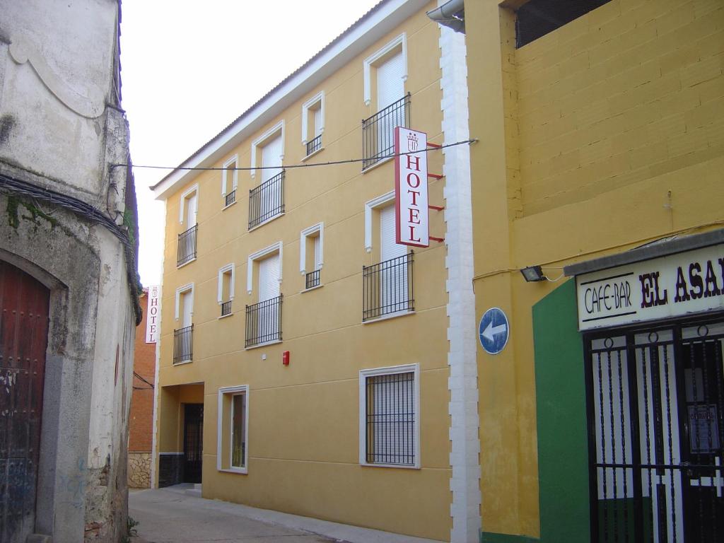a yellow building with a sign on the side of it at HOTEL PLAZA in Talarrubias