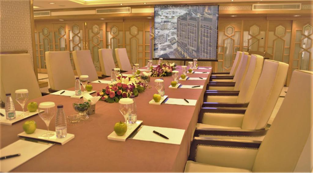 a large conference room with a long table and chairs at Makkah Towers in Mecca