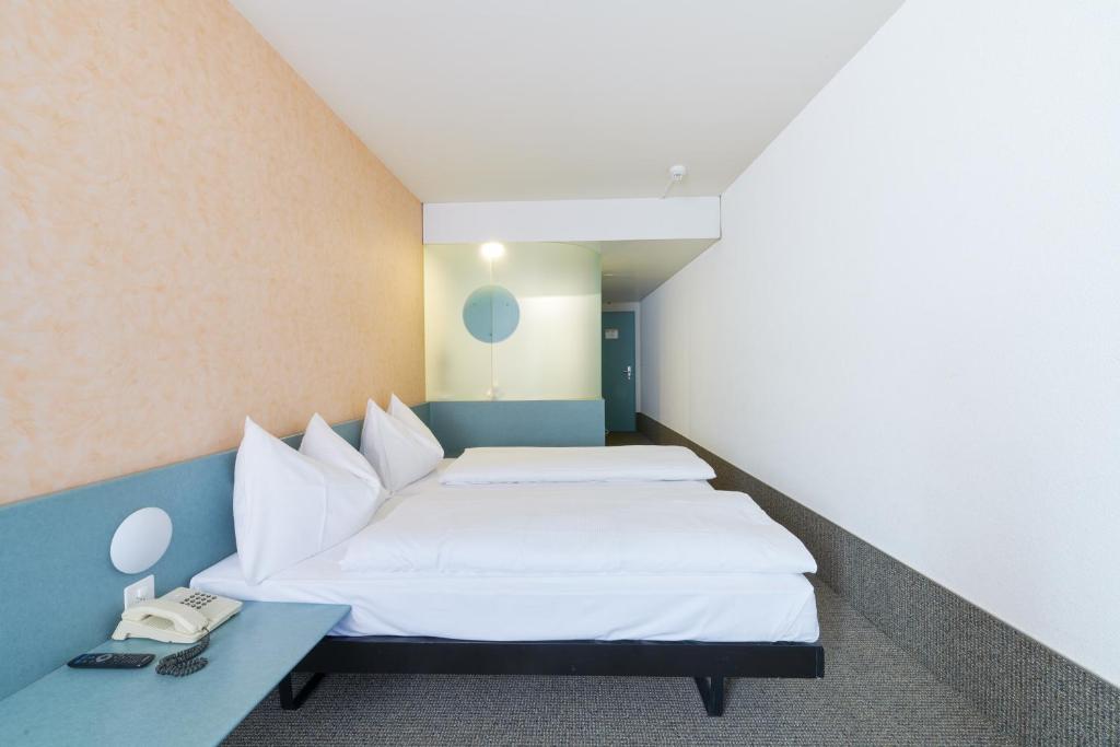 Postel nebo postele na pokoji v ubytování Hotel City am Bahnhof