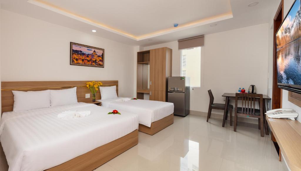 Giường trong phòng chung tại XO Hotel & Apartments