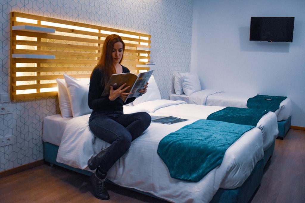 Postel nebo postele na pokoji v ubytování Athenian Montaza Hotel