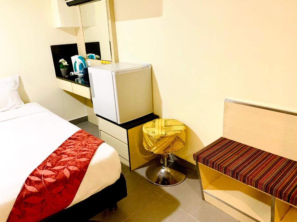 Postel nebo postele na pokoji v ubytování Sandpiper Hotel Singapore