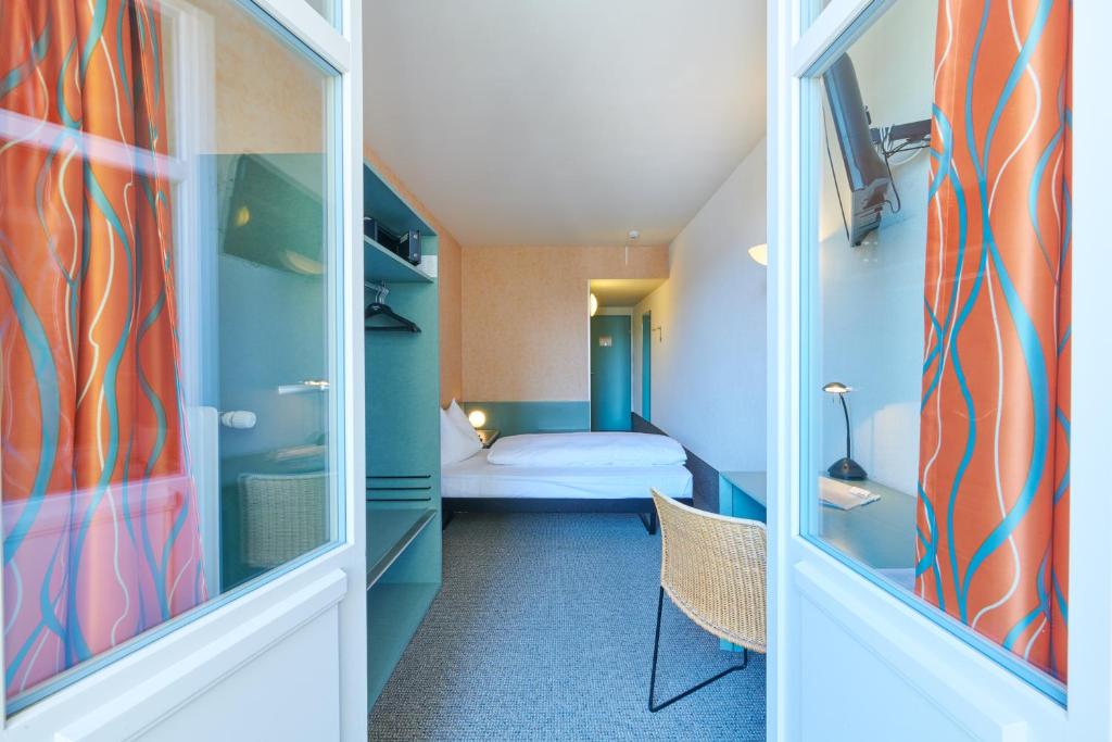 Postel nebo postele na pokoji v ubytování Hotel City am Bahnhof