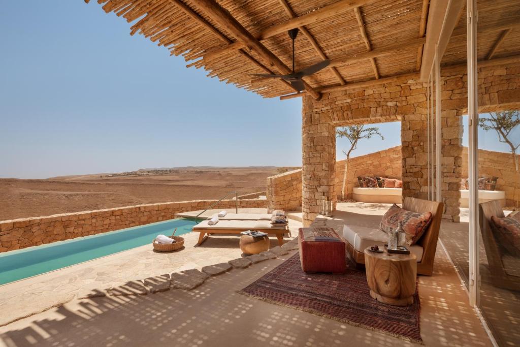 a house in the desert with a swimming pool at Six Senses Shaharut in Shaharut